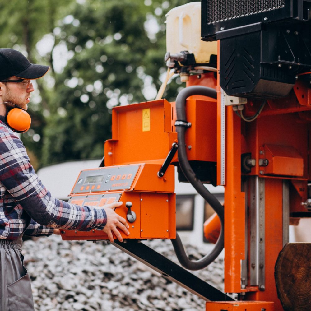 Carpenter working on a sawmill on a wood manufacture